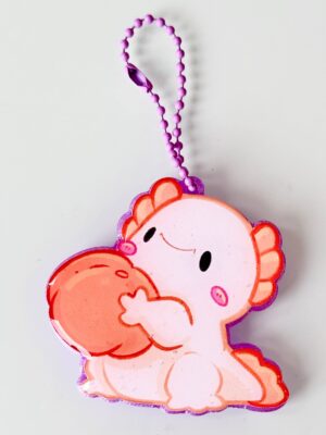 Smiling pink cartoon turkey cutout with orange wings and a purple beaded hanging loop.